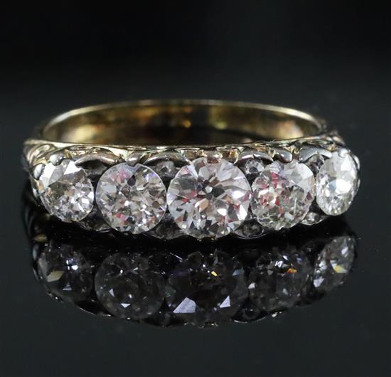 A Victorian style gold and graduated five stone diamond half hoop ring, size M.